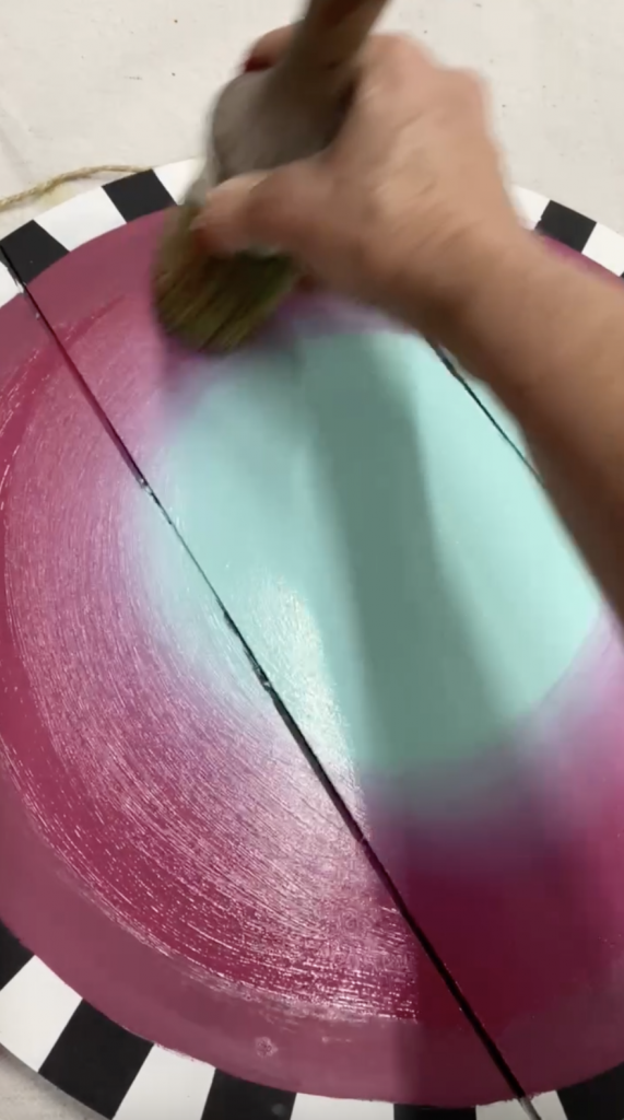 Tracey's Fancy blending the Gulf and Plum Crazy chalk mineral Dixie Belle Paint on her DIY door hanger with a best dang wax brush