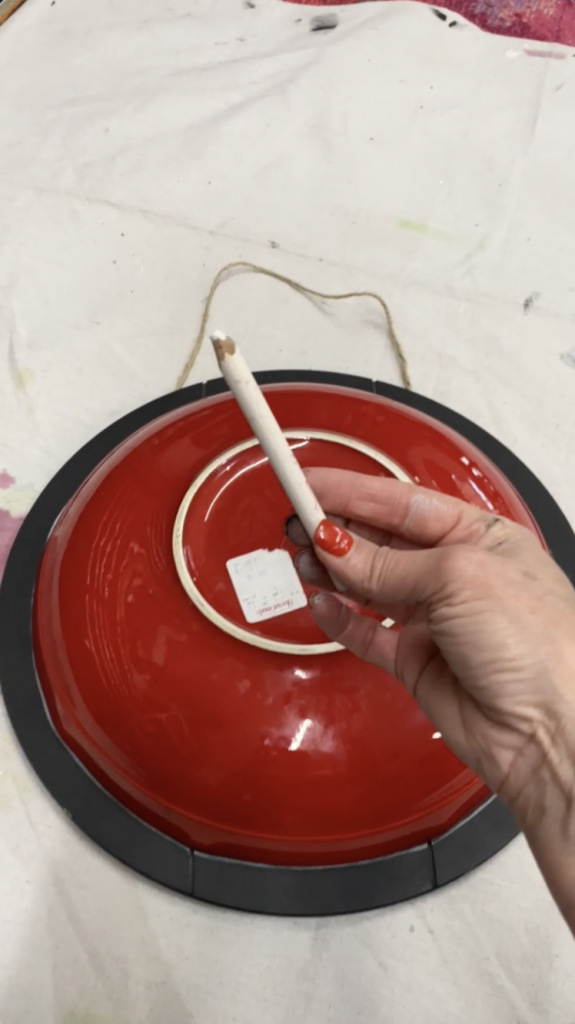 Tracey's Fancy using a bowl and a piece of chalk to outline the border of her diy door hanger