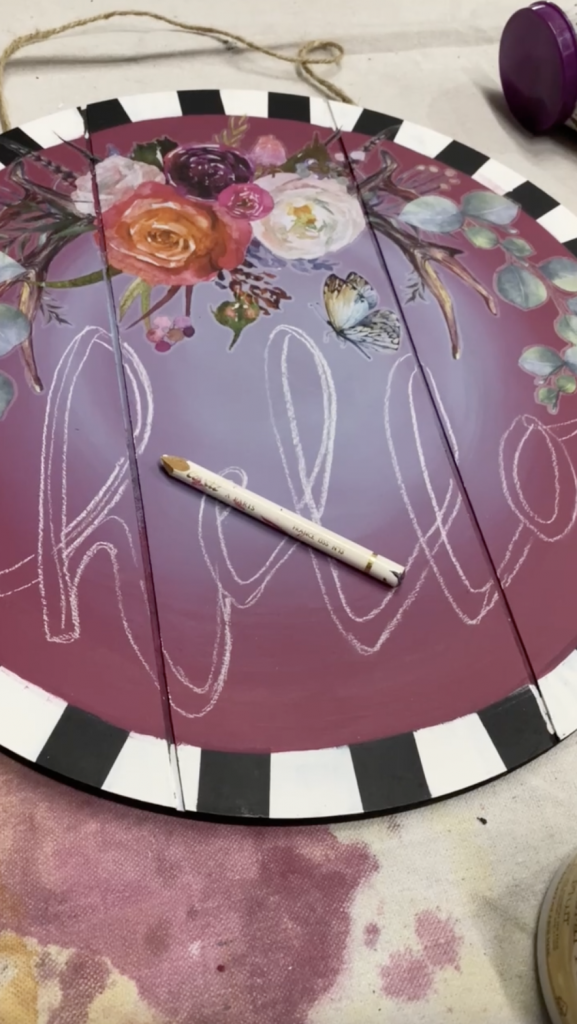 Tracey's Fancy DIY door hanger with boho design transfers, a striped, whimsical border, and the outline in chalk of the word Hello which she will be painting with Dixie Belle chalk mineral paint