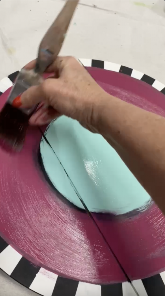 Tracey's Fancy applying chalk mineral paint to her DIY door hanger with a best dang wax brush