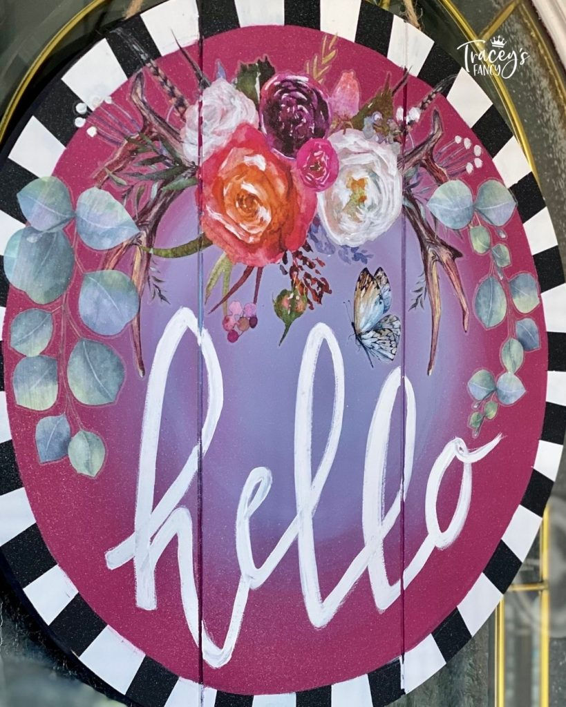 DIY floral boho door hanger design with plum crazy and the gulf blend and a striped border. Hello is written in decorative text by the whimsical artist Tracey's Fancy.