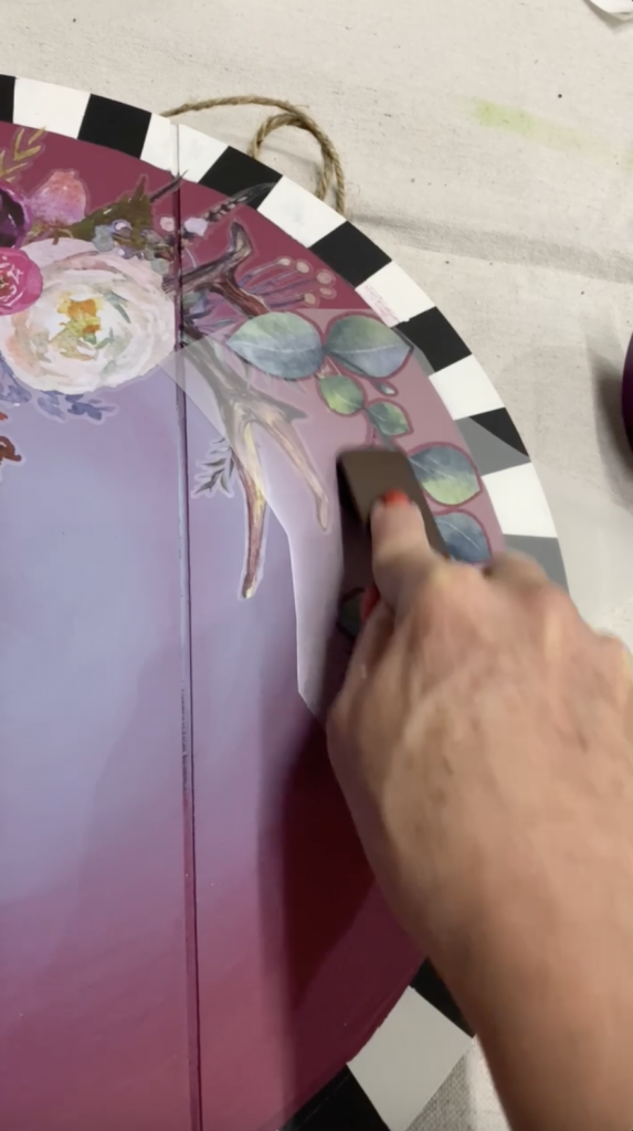Tracey's Fancy applying a design transfer to her DIY door hanger
