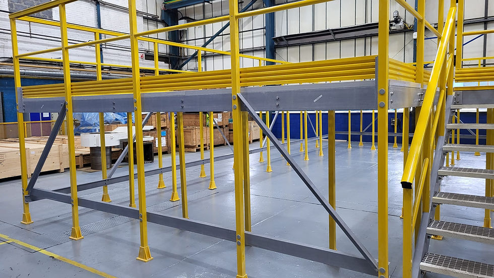 GRP platform with yellow handrails, grey moulded grating, and kick plates supplied by Kite Group for an MOD test and maintenance depot.