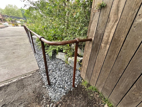 corner side of kite's bespoke mild steel handrail system supplied to Terrence Higgins Trust garden