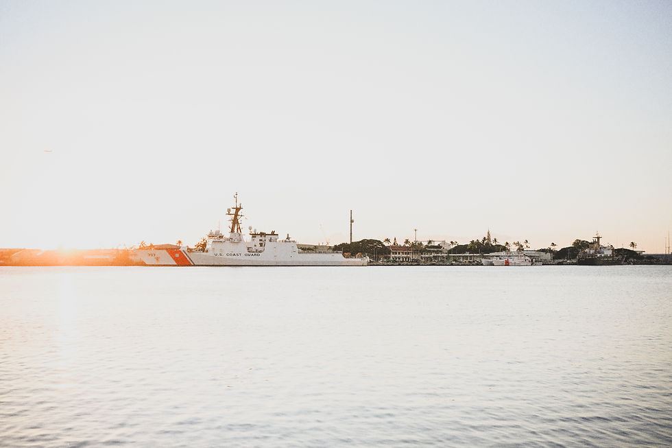 Interior corridor of the Royal Hawaiian Hotel, showing repeating columns, soft natural light, and historic Mediterranean-style design.