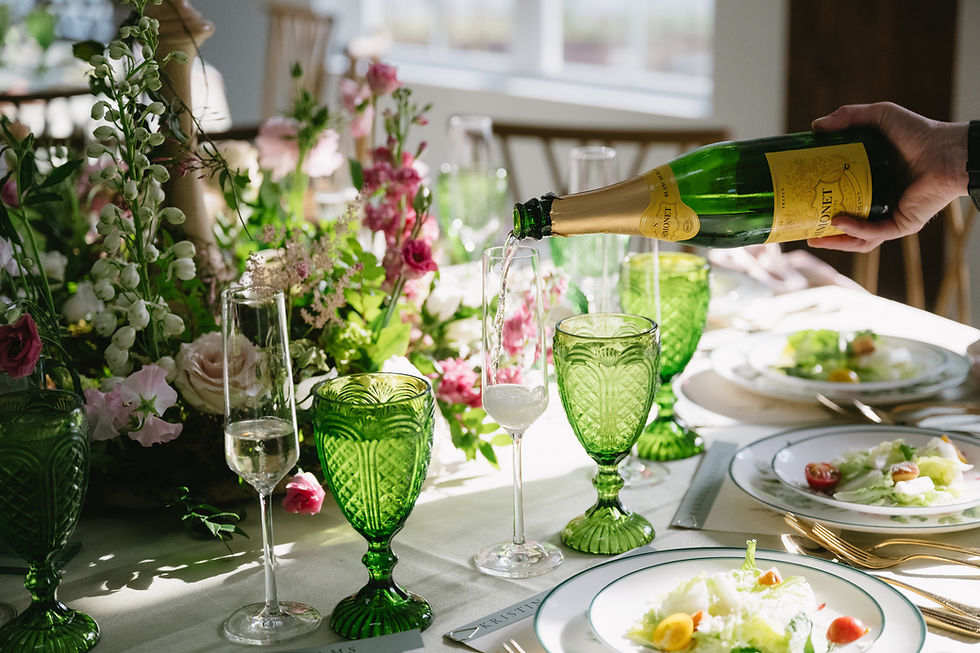 Raleigh wedding flowers tablescape with green glassware and floral centerpiece at Landon Estate in Clayton NC