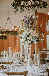 Blue and white elevated wedding centerpiece with hydrangea and delphinium at The Evermore in Apex, NC