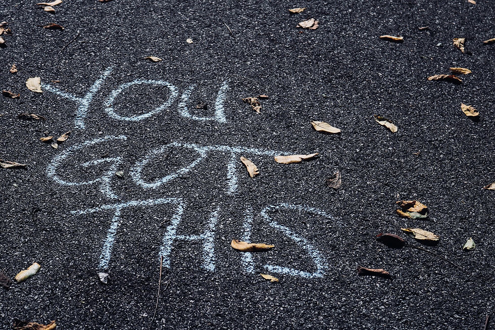 The words "you got this" written in chalk on pavement