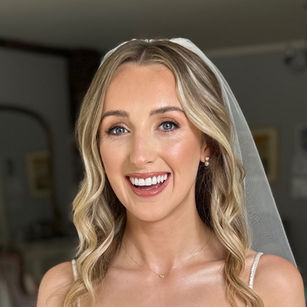 Blonde bride wearing natural, polished bridal makeup and a wedding veil