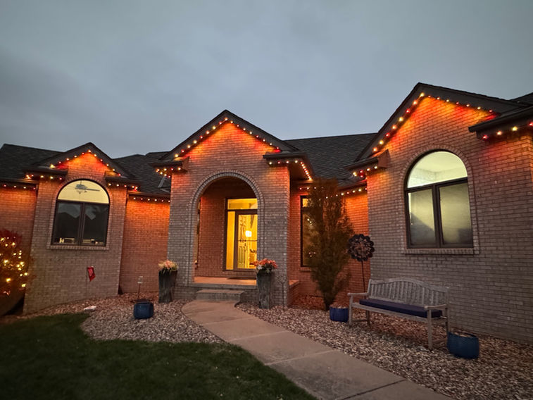 Permanent roofline lighting on a modern Omaha home with clean hidden install