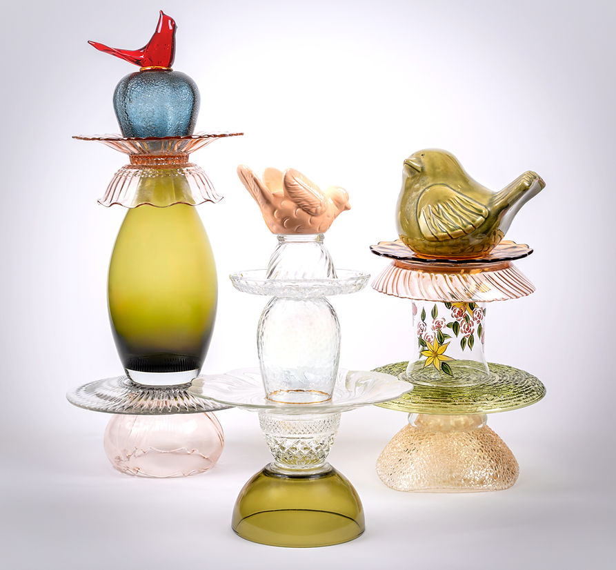 A grouping of three sculptures made with vintage glass, ceramics, and crystals