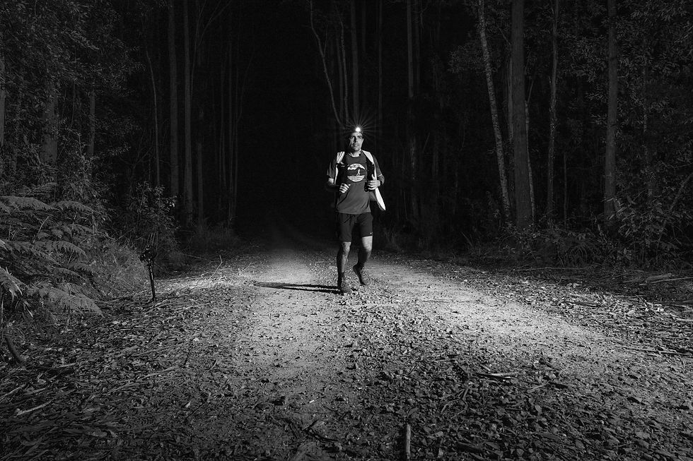 As night descends, a determined runner conquers the inaugural 100km ultra marathon, exemplifying endurance and resilience in the event's most challenging events - Photo Credits Keelan Birch