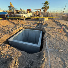 Oldcastle HS20‑rated electrical utility vault installed in excavated trench during underground power construction in Phoenix, Arizona.