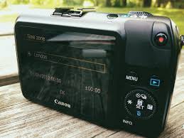 A Canon EOS M camera with Magic Lantern firmware installed, showcasing its compact design and ability to shoot 14-bit raw video."