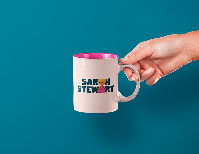 Mock up of vibrant logo design for Sarah Stewart. Hand holding mug with logo on a dark blue background