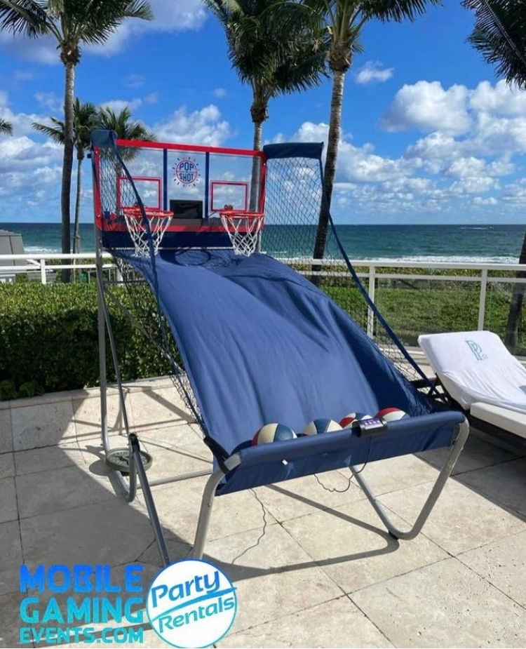 Two-player basketball arcade shootout with paired hoops and return lanes for repeated shooting rounds.