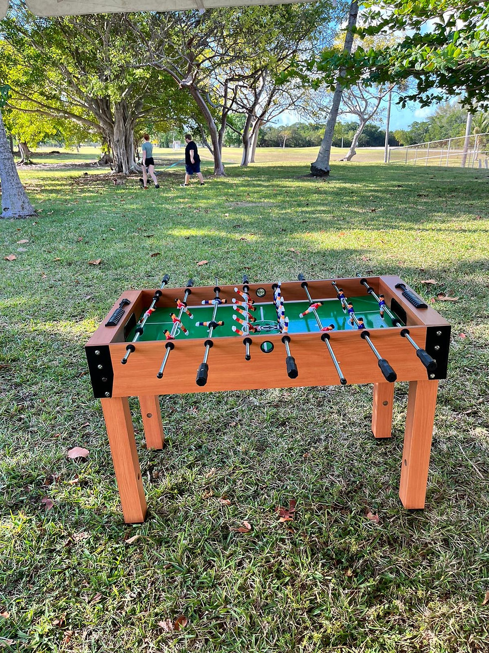 Orange foosball table set up outdoors