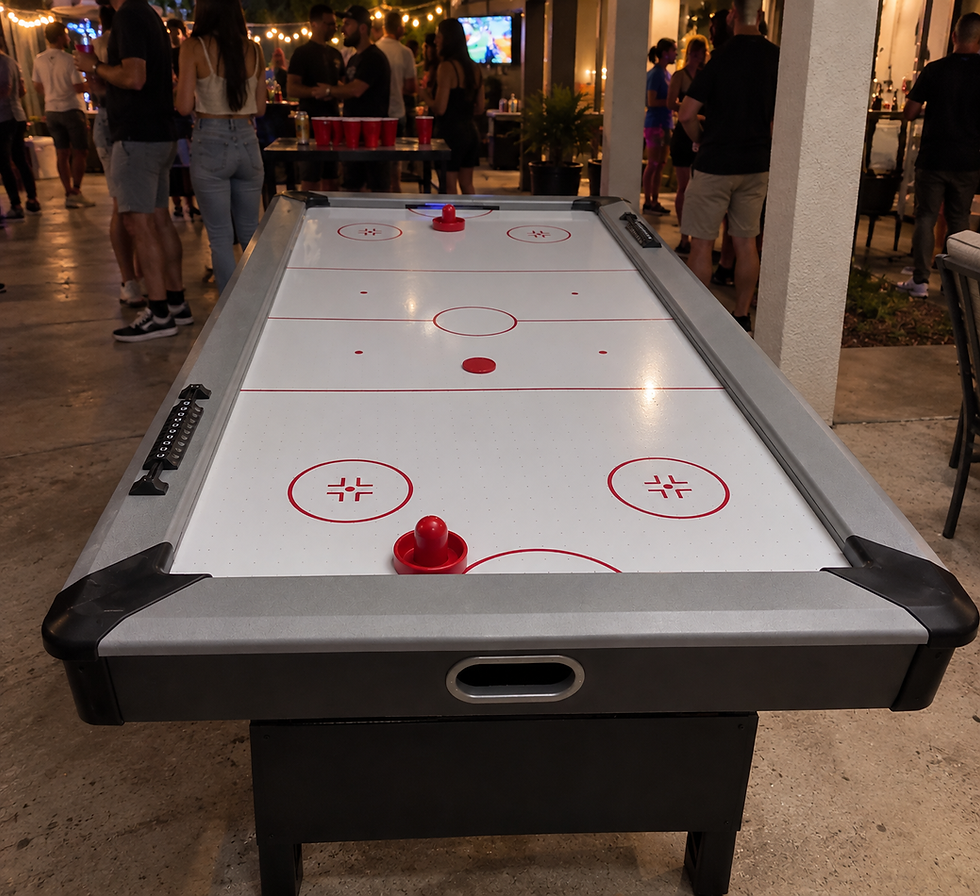 Air hockey table with red paddles at an event