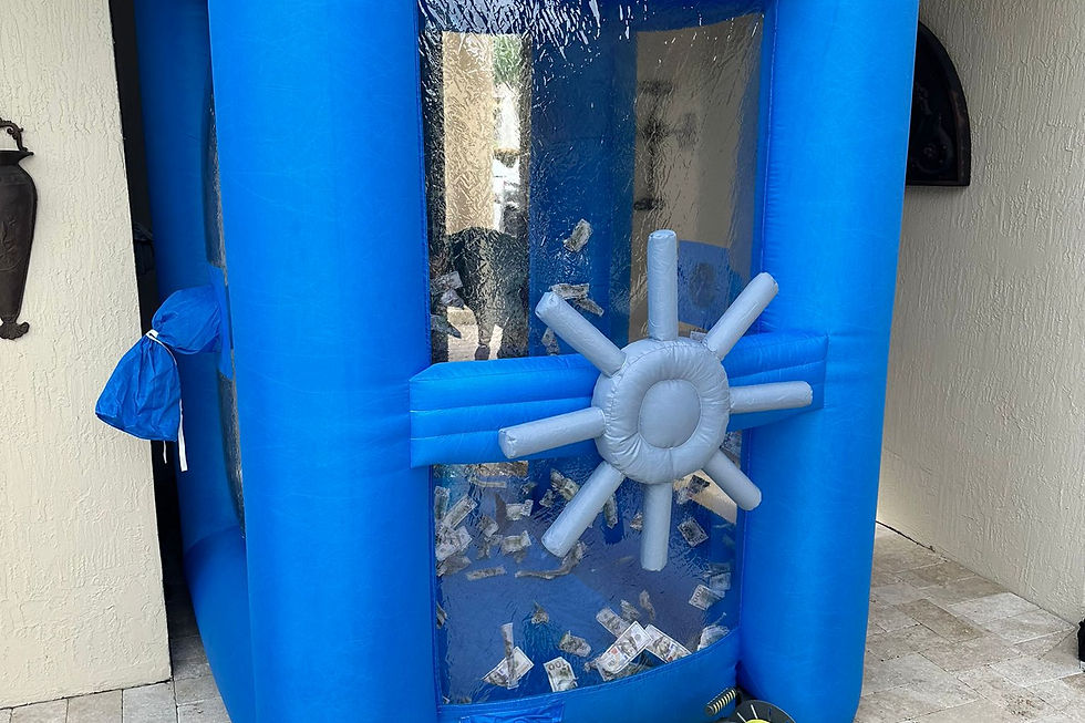 blue inflatable Cash Cube party rental shown from an angled view with transparent side panels and the interactive money machine enclosure for Fort Lauderdale, Broward County, and South Florida. This Cash Cube rental is relevant for birthday parties, corporate events, school events, HOA events, community celebrations, company parties, trade shows, festivals, and interactive event entertainment. Mobile Gaming Events provides mobile party and event rentals with setup brought to the event location. Call or text 954-408-1881 for availability.