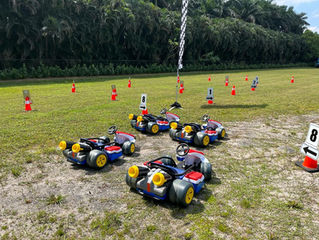 Mario Kart Ride-On Racers on a party race course with numbered gates.