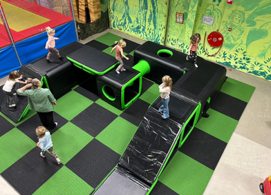 Indoor soft playground setup for children with inflatable activity areas for birthday parties and school events in Broward County.