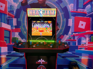 NBA Jam standup arcade cabinet in front of a basketball-themed backdrop