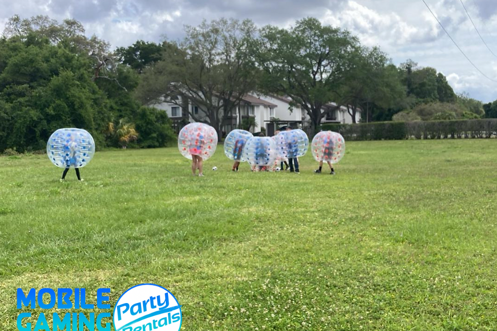 Bubble Soccer rental from Mobile Gaming Events featuring inflatable bubble suits bubble balls soccer goals and supervised team gameplay for birthday parties school events summer camps church youth groups corporate events Bar and Bat Mitzvahs HOA celebrations festivals family events and community gatherings in Roswell. This image represents the Bubble Soccer service offered for events in and around Roswell and does not necessarily mean the photographed event itself took place there. Call or text 954-408-1881 for availability.