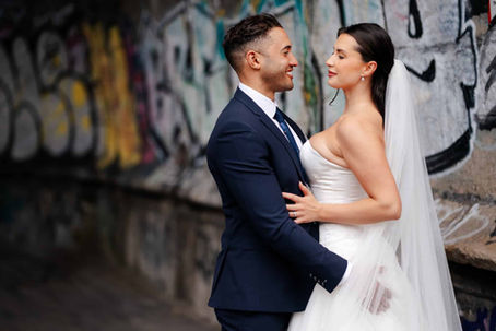 bride and groom in graffiti tunnel