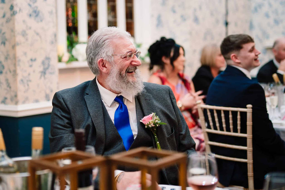 candid guest laughing during wedding day speeches