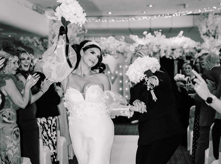 two brides walking back down aisle after being married