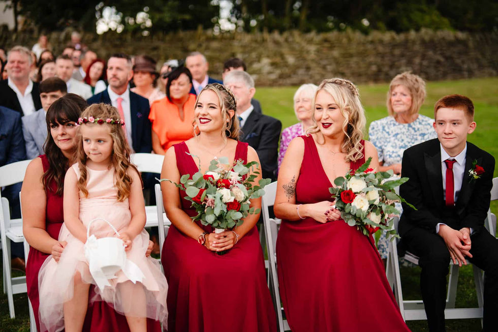 candid wedding guests during outdoor ceremony