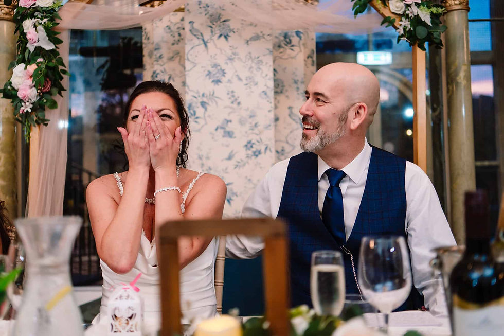 bride and groom laughing during wedding speech