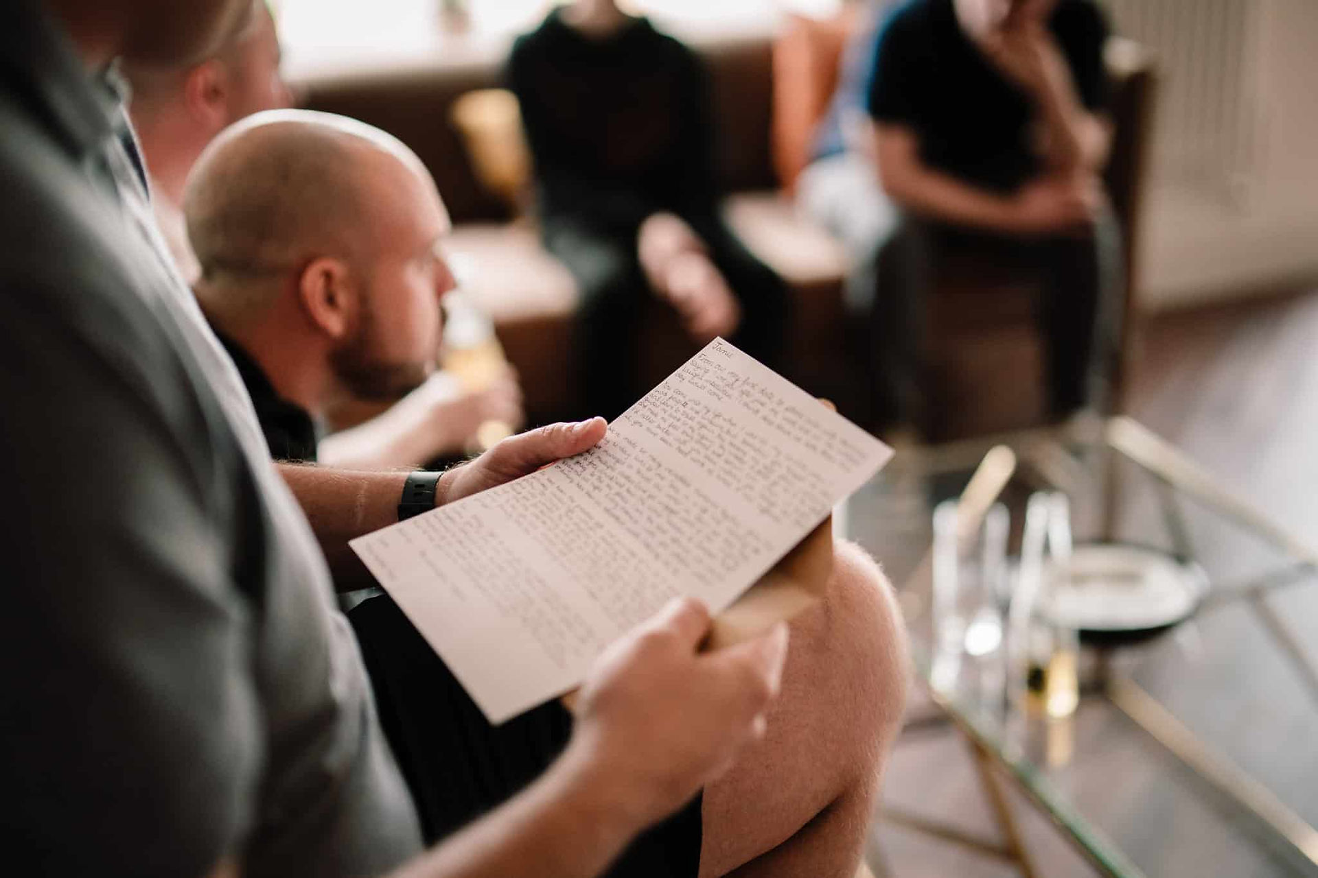 groom reading letter from brider to be on wedding day
