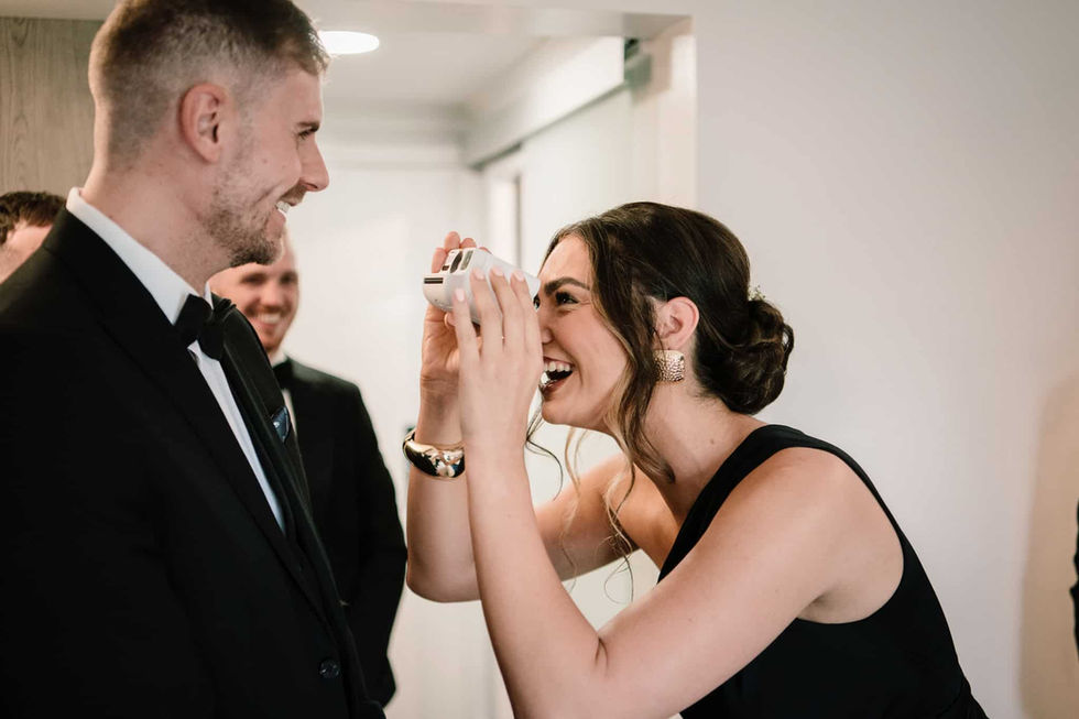 wedding guest taking photo with polaroid camera