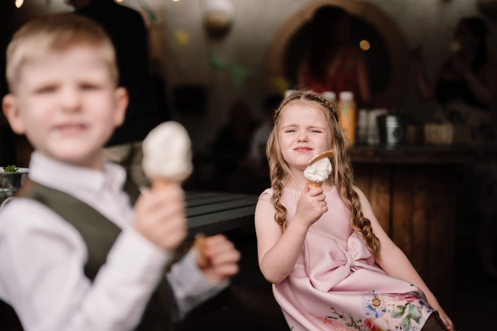 Young children eating ice creams on wedding day