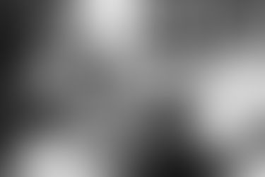 bride and groom holding hands at sunset with castle behind them