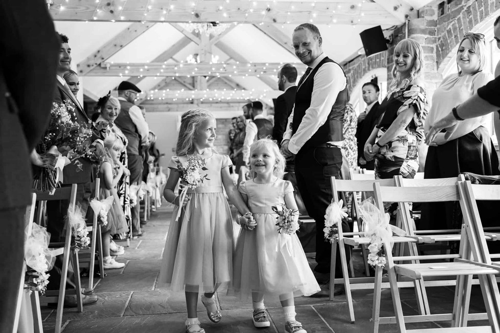 black and white photo of flower girls walking down aisle howard court north yorkshire