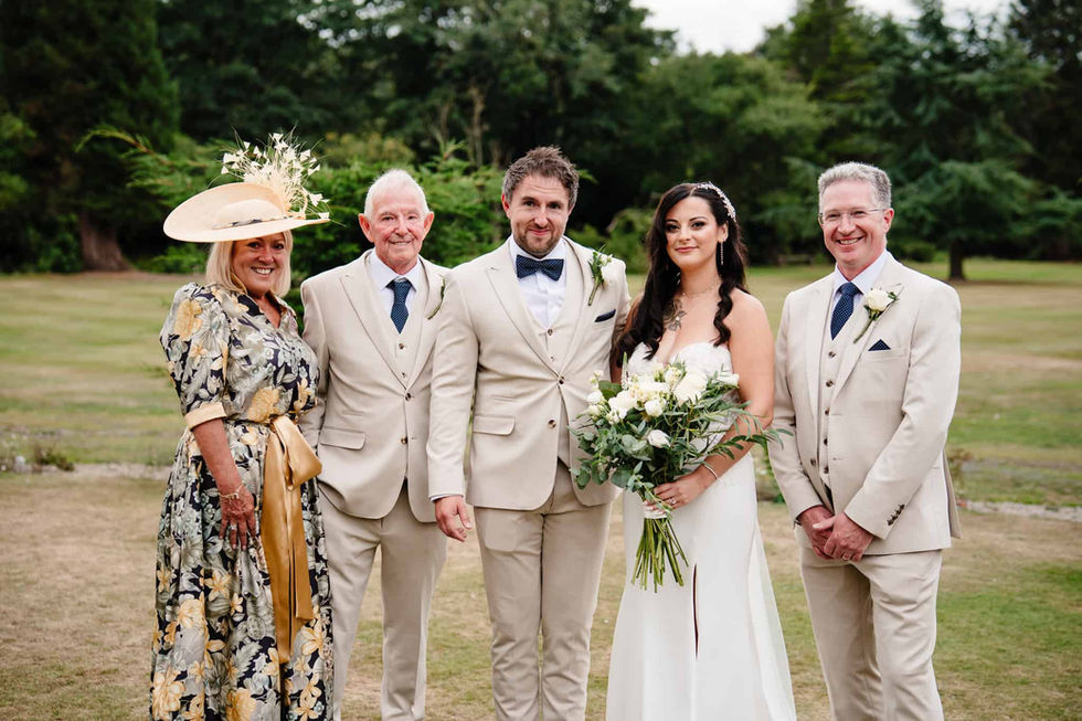 bride and groom with parents formal group portrait at beamish hall wedding venue