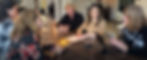 5 women sitting at a table carrying on a conversation