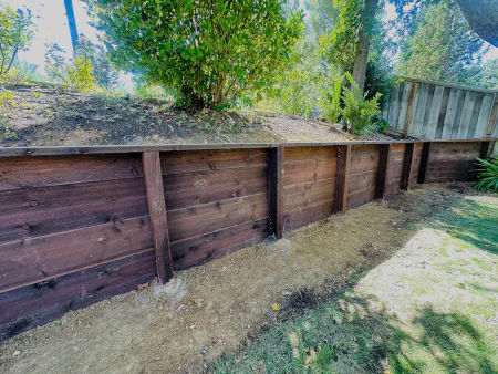 Wood retaining wall and slope support projects for residential yards.