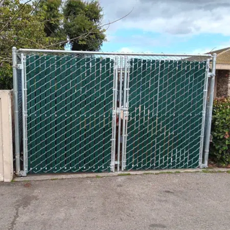 Chain link double gate installed for secure property access.