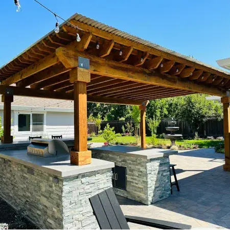 Custom wood patio cover with solid roof over residential outdoor living space