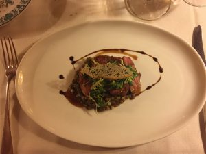 The starter is gently smoked duck breast on apple lentil salad and aged balsamico