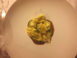 Tortelloni filled with parmesan cheese fonduta on leek cream and truffle jus at the restaurant of Elephant Hotel in Brixen