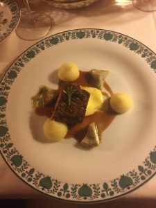 The veal filet in crunchy onions with artichoke, potatoes and sauce Hollandaise