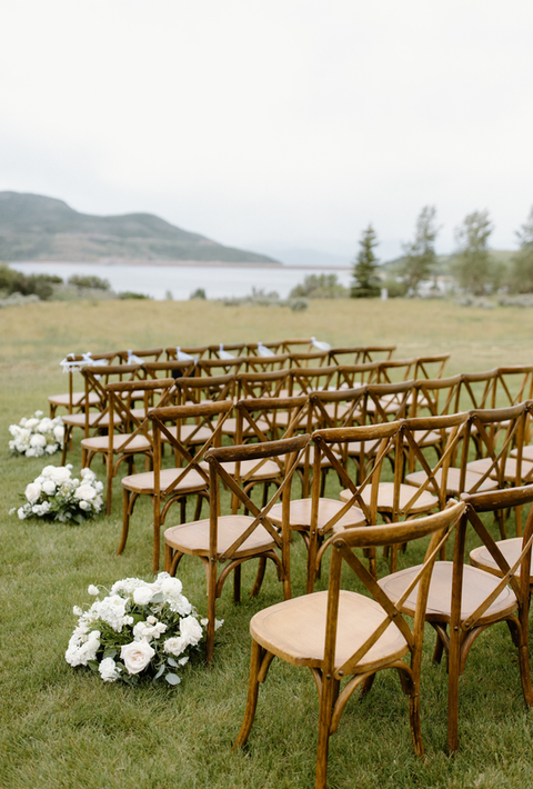 a wedding ceremony next to a lake