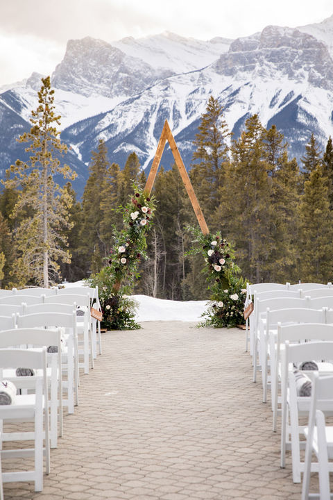 mountain looking wedding ceremony with white chairs 