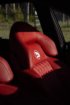Red leather interior seat on commodore Calais. Photography in sunlight. Leather protection.