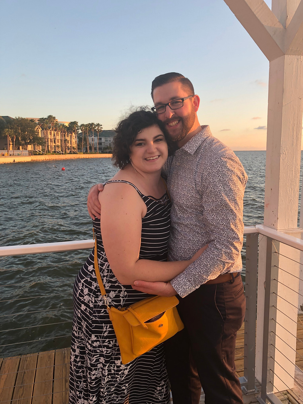 A man and woman hug on a deck in Tampa FL