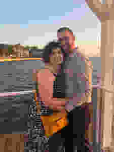 A man and woman hug on a deck in Tampa FL